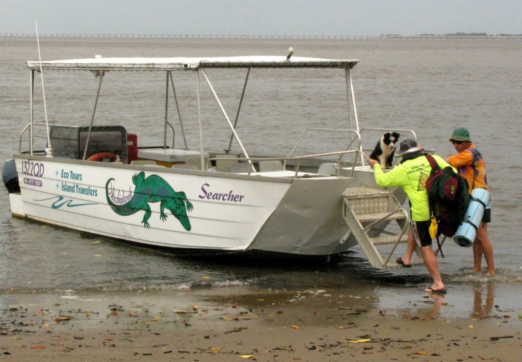 Backpacker Catching Ferry at George Point, Hinchinbrook Island, Queensland (© Vilis Nams)